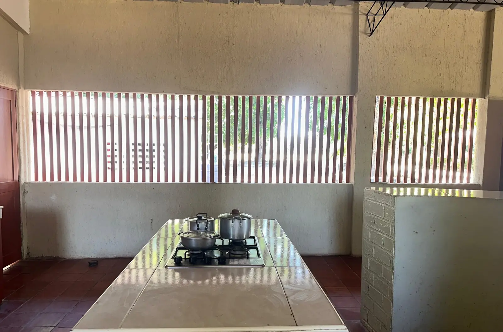 Mesón central con estufa de gas en la cocina remodelada de Finca La Curva
